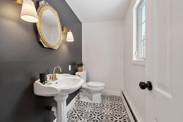 bathroom featuring tile patterned floors, baseboard heating, a healthy amount of sunlight, and baseboards