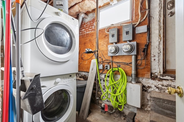 clothes washing area featuring stacked washer / drying machine