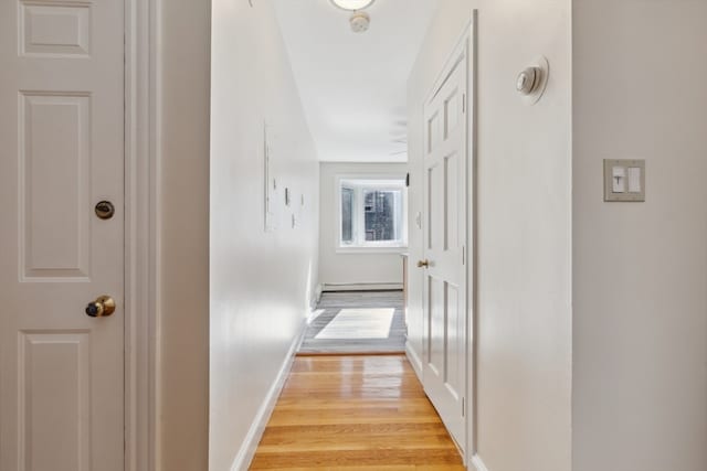 corridor with light hardwood / wood-style floors