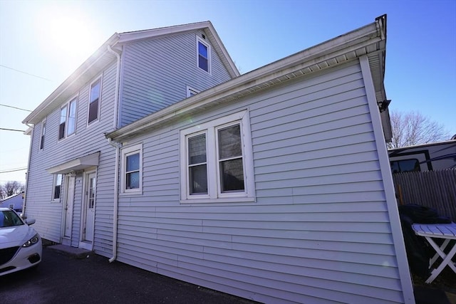 view of side of home featuring fence