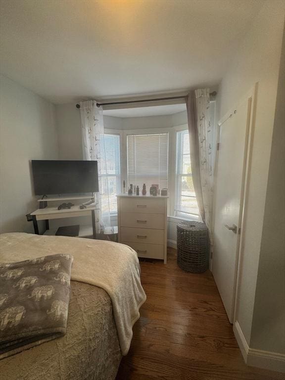 bedroom featuring dark wood-type flooring