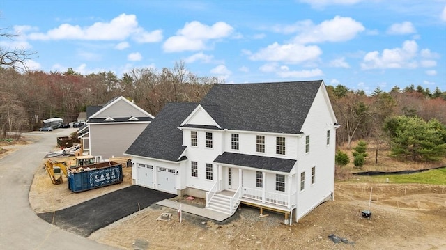 66 Parish Rd Unit 3, Georgetown, MA 01833 - view of front facade featuring asphalt driveway, roof with shingles, an attached garage, and covered porch
