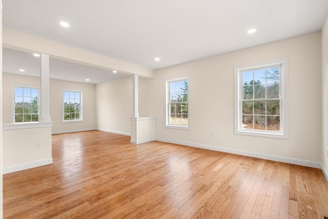 unfurnished room with baseboards, recessed lighting, and light wood-style floors