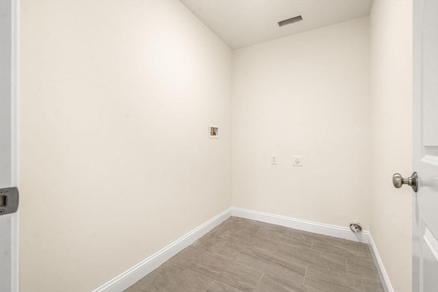 laundry room featuring laundry area, visible vents, hookup for a washing machine, and baseboards