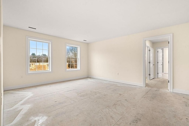 unfurnished room with visible vents and baseboards