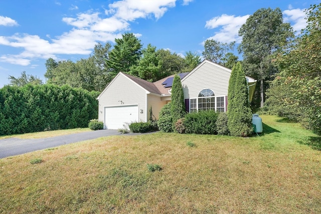 view of front facade with a front yard and a garage