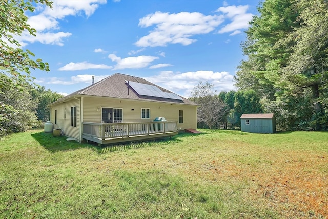 exterior space featuring a wooden deck, a yard, and a storage unit