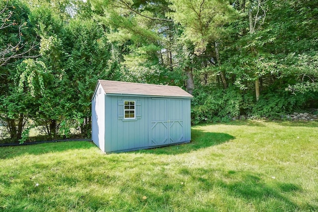 view of outbuilding with a lawn