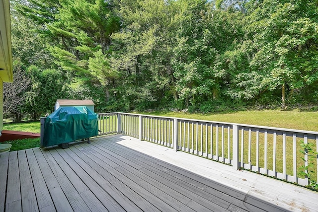 wooden terrace featuring a yard