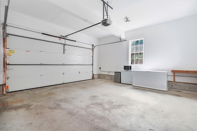 garage featuring a garage door opener and refrigerator