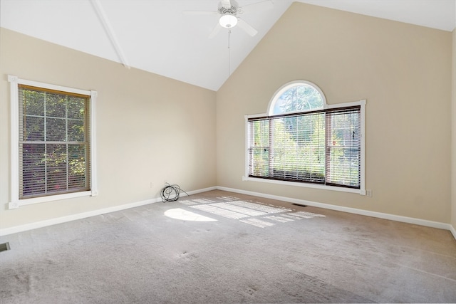 spare room with ceiling fan, light carpet, and high vaulted ceiling