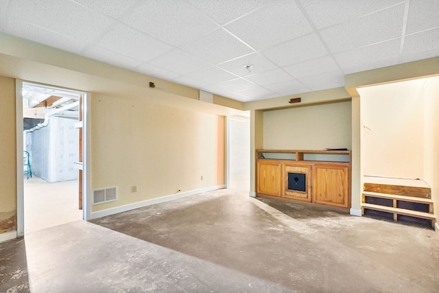 unfurnished living room with a paneled ceiling