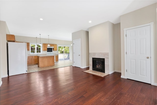 unfurnished living room with light wood-type flooring and a fireplace