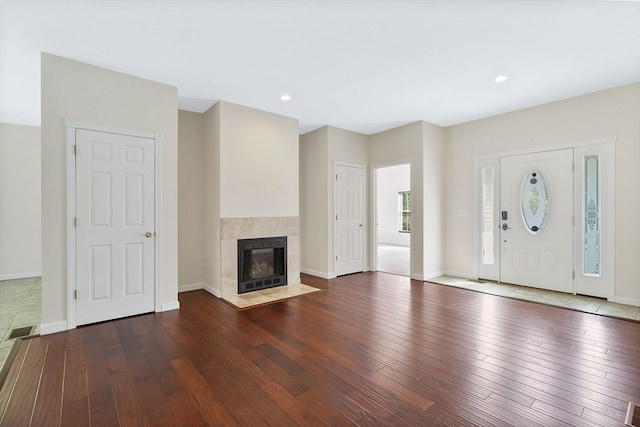 unfurnished living room with a fireplace and dark hardwood / wood-style flooring