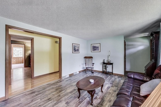 49 Lady Slipper Dr, Dennis, MA 02638 - living area with baseboards, a textured ceiling, and wood finished floors