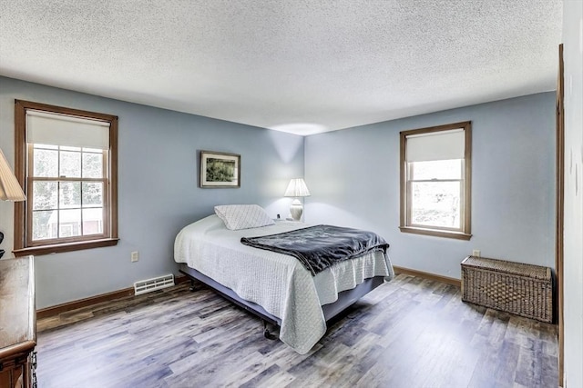 49 Lady Slipper Dr, Dennis, MA 02638 - bedroom with multiple windows, wood finished floors, and visible vents