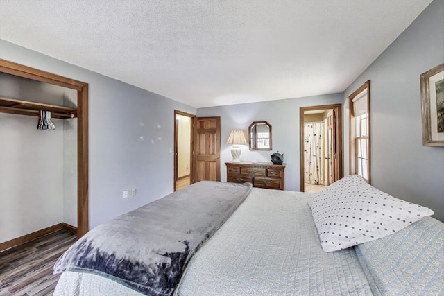 49 Lady Slipper Dr, Dennis, MA 02638 - bedroom with a textured ceiling, baseboards, wood finished floors, and a closet