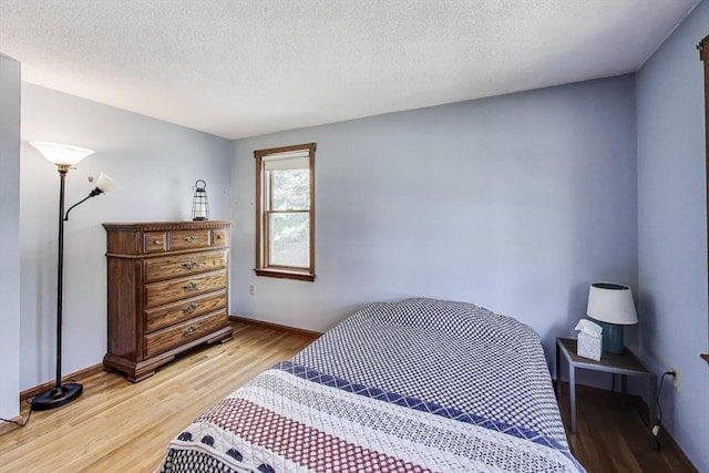 49 Lady Slipper Dr, Dennis, MA 02638 - bedroom featuring baseboards, light wood finished floors, and a textured ceiling