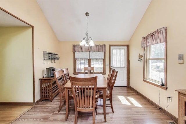 49 Lady Slipper Dr, Dennis, MA 02638 - dining space featuring an inviting chandelier, vaulted ceiling, and light wood-style flooring