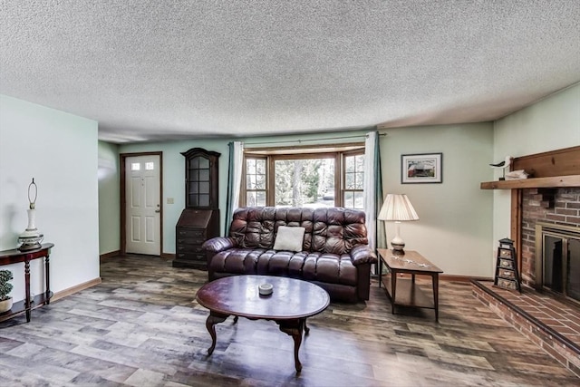 49 Lady Slipper Dr, Dennis, MA 02638 - living room with a textured ceiling, baseboards, a fireplace, and wood finished floors