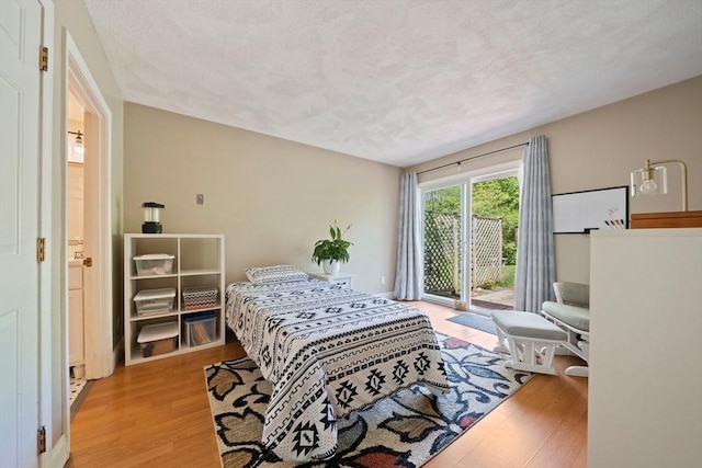 23 Rufus Jones Ln Unit 23, Easton, MA 02356 - bedroom featuring access to outside, wood finished floors, and a textured ceiling