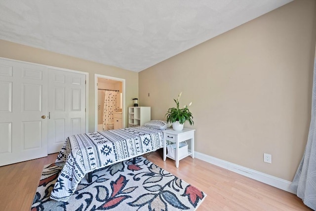 23 Rufus Jones Ln Unit 23, Easton, MA 02356 - bedroom featuring baseboards, wood finished floors, and ensuite bathroom