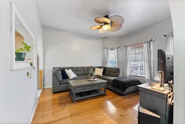 living room with ceiling fan and light wood-type flooring