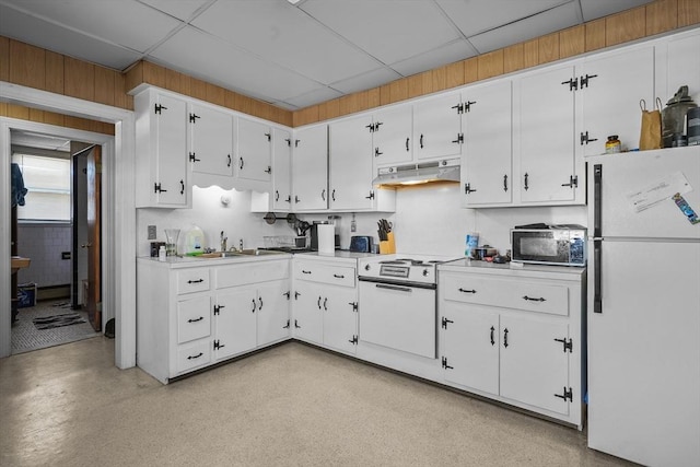 kitchen with a drop ceiling, sink, white fridge, cooktop, and white cabinetry