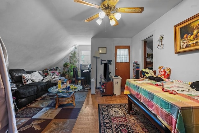 bedroom with dark parquet flooring, ceiling fan, and lofted ceiling