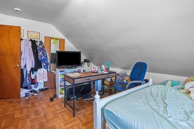 bedroom with lofted ceiling and light parquet flooring