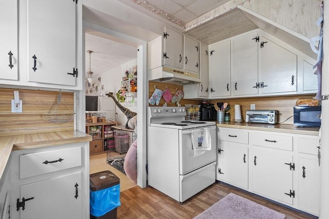 kitchen with white range with electric stovetop, decorative backsplash, white cabinetry, and hardwood / wood-style floors