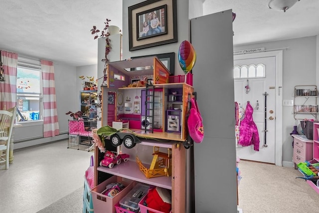 recreation room featuring a baseboard heating unit