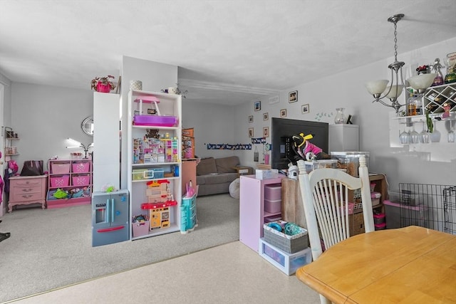 recreation room with carpet flooring and a notable chandelier