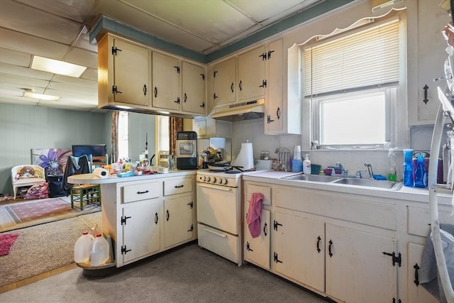 kitchen with a healthy amount of sunlight, white range oven, sink, and cream cabinets