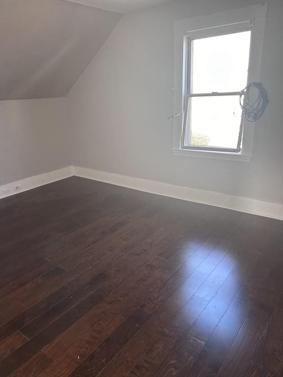 bonus room featuring dark hardwood / wood-style floors and vaulted ceiling