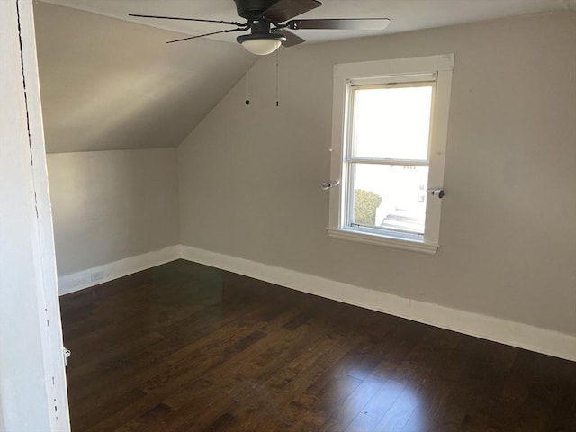 additional living space with ceiling fan, dark hardwood / wood-style flooring, and vaulted ceiling