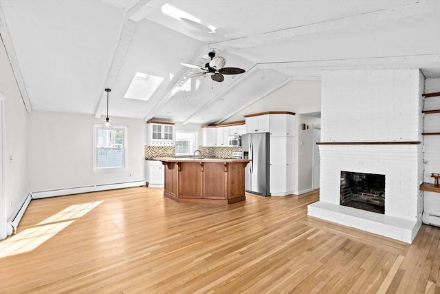 51 Shore Dr, Plymouth, MA 02360 - kitchen featuring open floor plan, stainless steel appliances, a skylight, ceiling fan, and a kitchen breakfast bar