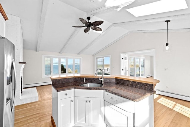 51 Shore Dr, Plymouth, MA 02360 - kitchen featuring a sink, a baseboard heating unit, stainless steel fridge, light wood finished floors, and a center island with sink