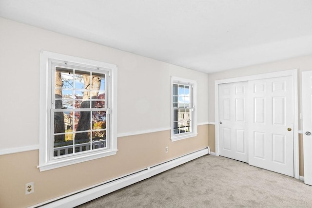 51 Shore Dr, Plymouth, MA 02360 - unfurnished bedroom with baseboard heating, multiple windows, carpet floors, and a closet