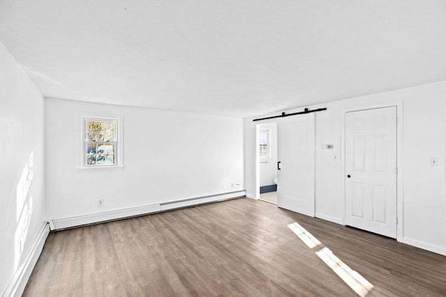 51 Shore Dr, Plymouth, MA 02360 - unfurnished bedroom with a baseboard radiator, a barn door, wood finished floors, and multiple windows