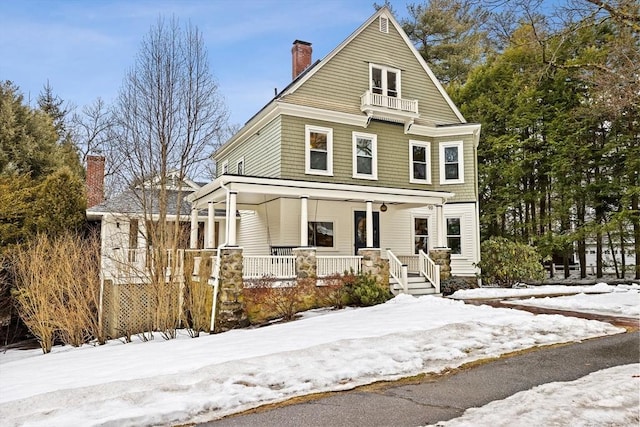 view of front of property with a porch and a chimney