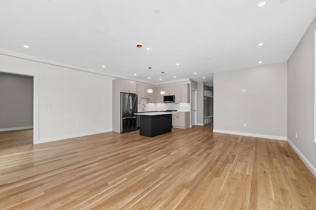 42 Waverly Unit 1, Boston, MA 02135 - unfurnished living room featuring a sink, light wood-style floors, recessed lighting, and baseboards