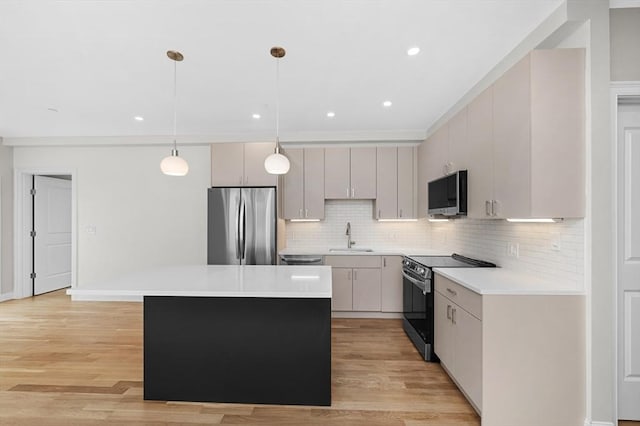 42 Waverly Unit 1, Boston, MA 02135 - kitchen with appliances with stainless steel finishes, a sink, a kitchen island, light countertops, and decorative backsplash