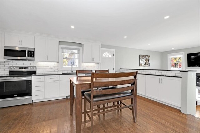 110 Walnut St, Canton, MA 02021 - kitchen with appliances with stainless steel finishes, a sink, plenty of natural light, backsplash, and recessed lighting