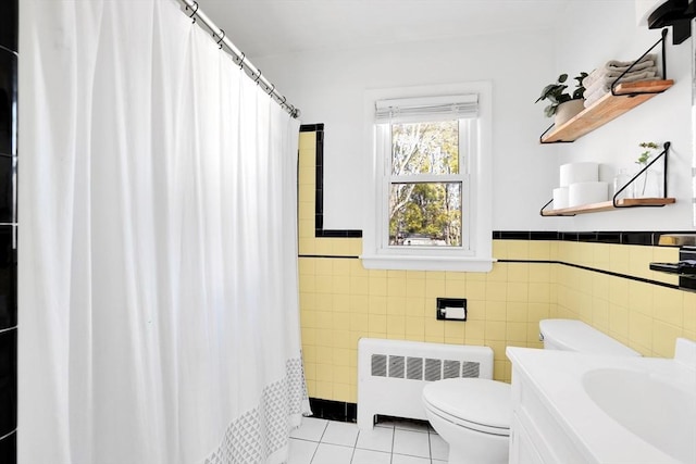 110 Walnut St, Canton, MA 02021 - bathroom featuring radiator heating unit, tile patterned floors, tile walls, toilet, and a wainscoted wall