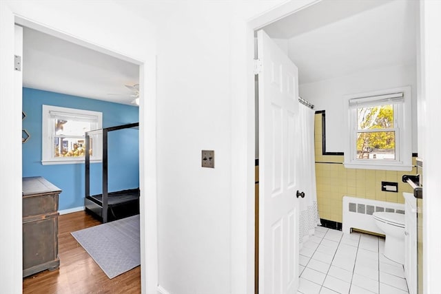 110 Walnut St, Canton, MA 02021 - bathroom with tile walls, radiator heating unit, a shower with shower curtain, toilet, and a ceiling fan