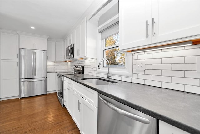 110 Walnut St, Canton, MA 02021 - kitchen featuring appliances with stainless steel finishes, a sink, white cabinets, and recessed lighting