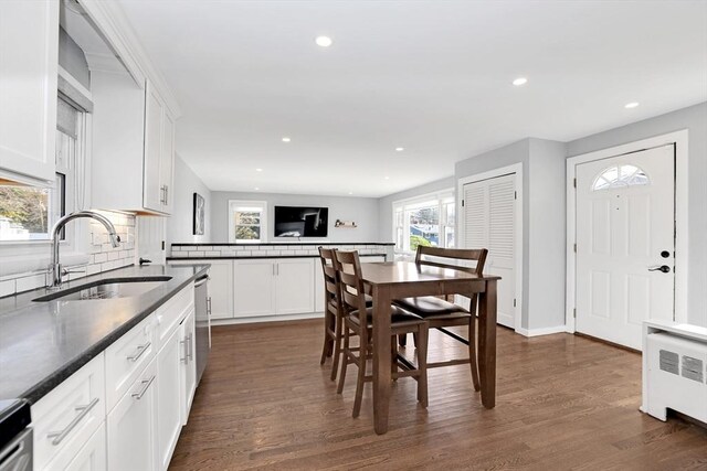 110 Walnut St, Canton, MA 02021 - kitchen featuring a sink, dark wood-style floors, decorative backsplash, recessed lighting, and dark countertops