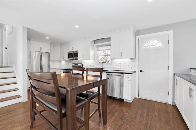 110 Walnut St, Canton, MA 02021 - kitchen featuring appliances with stainless steel finishes, backsplash, white cabinets, dark wood finished floors, and recessed lighting