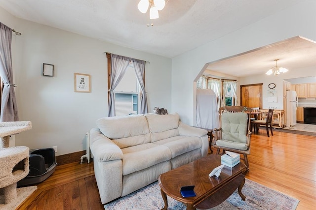 25 Garrison St, Fairhaven, MA 02719 - living area featuring light wood-style flooring, plenty of natural light, and a chandelier